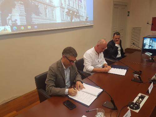 La firma dell'intesa fra Regione e Comunità Costiera. In primo piano l'assessore Pierpaolo Roberti. Al suo fianco Alberto Scheriani, presidente della Comunità Costiera.