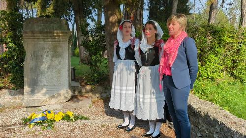 Un momento della cerimonia nel parco della chiesa di Sant'Eufemia a Segnacco di Tarcento innanzi il cippo a memoria di Chino Ermacora con i danzerini